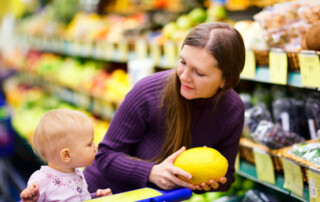 Woman produce shopping with her child.