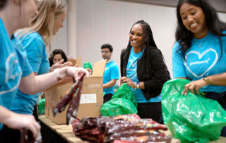 NRG volunteers assembling Backpack Buddy meal kits